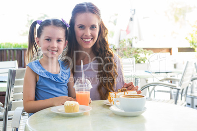 Mother and daughter at cafe terrace
