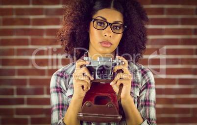 Attractive focused hipster photographing