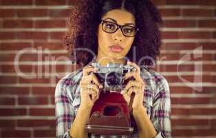 Attractive focused hipster photographing
