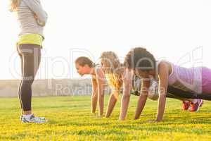 Sporty women doing push ups during fitness class