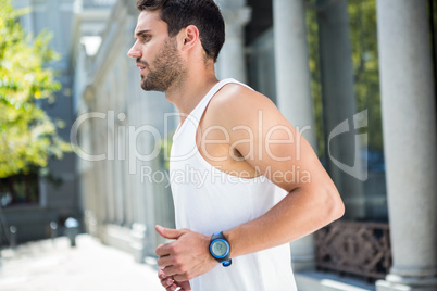 Determined handsome athlete jogging