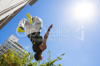 Extreme athlete jumping in the air in front of a building