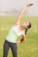 Sporty woman stretching arms