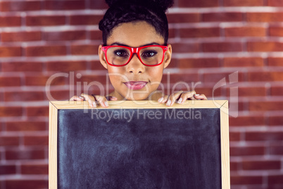 Portrait of a female hipster holding a blackboard