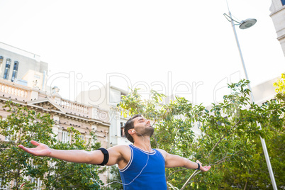Handsome athlete with arms outstretched
