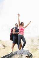 Young happy joggers posing on rock