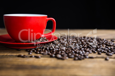 Coffee beans on a table with cup