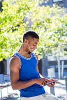 Smiling athletic man using tablet computer