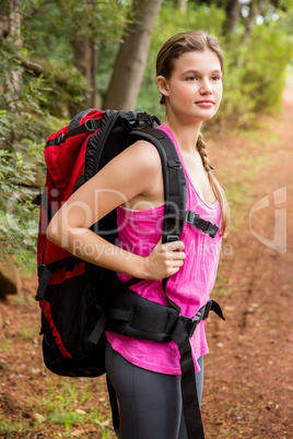 Smiling blonde hiker with backpack