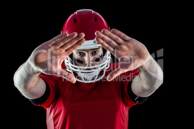 Portrait of american football player protecting himself