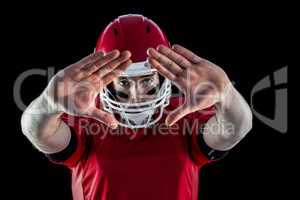 Portrait of american football player protecting himself