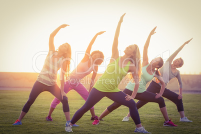 Sporty women warming up during fitness class