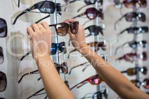 Woman picking out new sunglasses