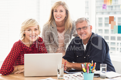 Smiling business team looking at the camera