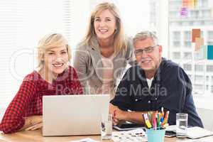 Smiling business team looking at the camera