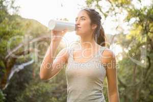 Pretty athletic brunette drinking out of bottle