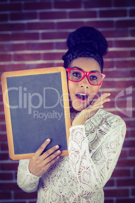 Portrait of a female hipster holding a blackboard