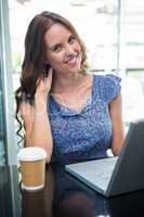 Pretty brunette using her laptop