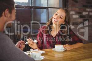 Pretty brunette enjoying cake and coffee with friend