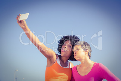 Two sporty women posing and taking selfies