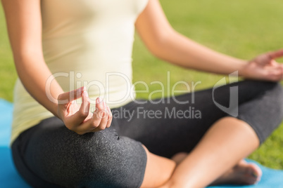 Fit woman meditating on exercise mat