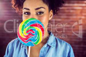 A beautiful woman holding a giant lollipop