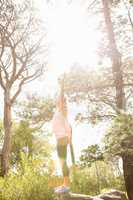 Carefree blonde hiker with arms outstretched