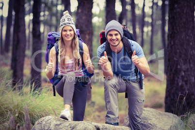 Portrait of a happy hiker couple with thumbs up