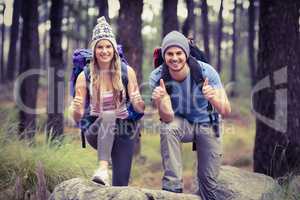 Portrait of a happy hiker couple with thumbs up