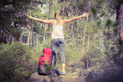 Carefree blonde hiker with arms outstretched