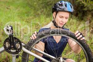 Athletic blonde checking her mountain bike
