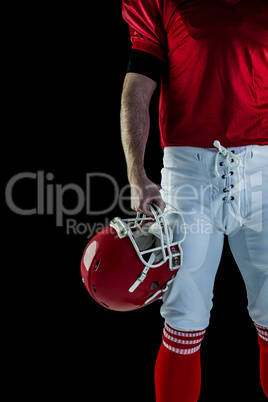 American football player holding his helmet