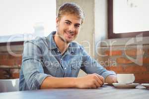 Handsome man having cup of coffee