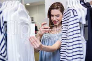 Brunette taking a photo of price tag