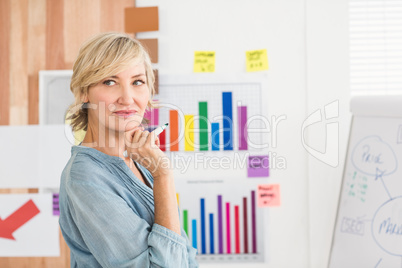 Thoughtful businesswoman writing on a white board