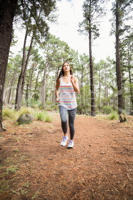 Young happy jogger walking