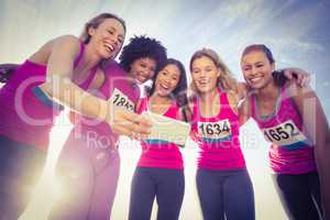 Runners supporting breast cancer marathon and taking selfies