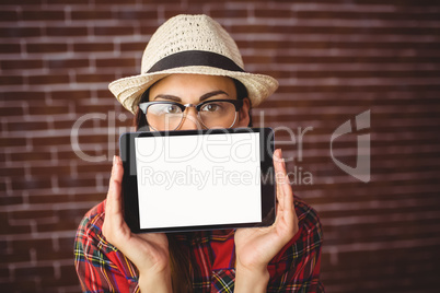 Beautiful hipster showing tablet to camera