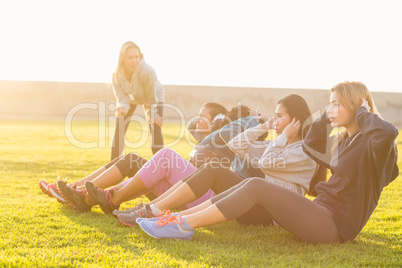 Sporty women doing sit ups during fitness class