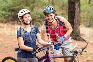 Happy handsome biker couple looking at camera