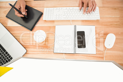 Hands working with computer and digitizer