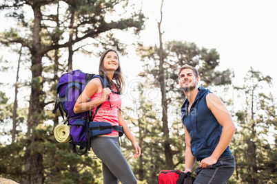 Young happy joggers standing on rock looking away