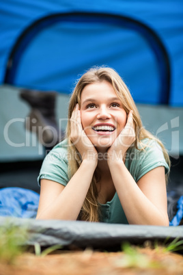 Young pretty hiker lying in a tent