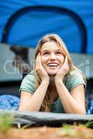 Young pretty hiker lying in a tent