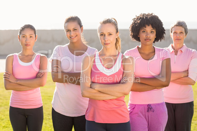 Women wearing pink for breast cancer with arms crossed