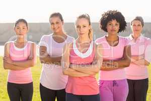 Women wearing pink for breast cancer with arms crossed