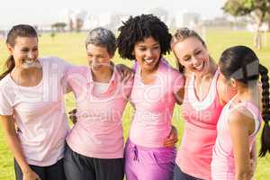 Laughing women wearing pink for breast cancer
