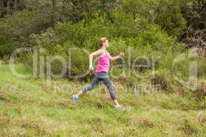 Pretty blonde athlete jogging