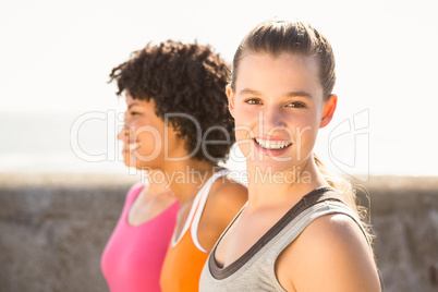 Smiling sporty woman with two friends