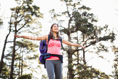 Young happy jogger standing on rock feeling free